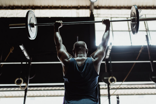 Man doing strength training with barbell for muscle gain