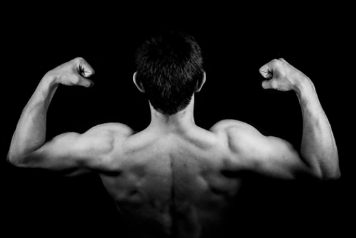 Person showcasing muscular back in a workout setting