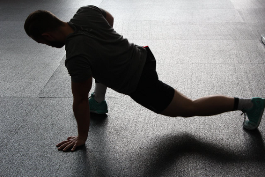 A person performing a leg stretch exercise at home