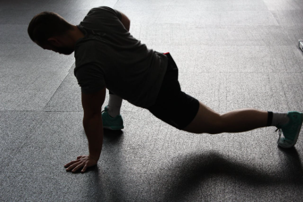 A person performing a leg stretch exercise at home