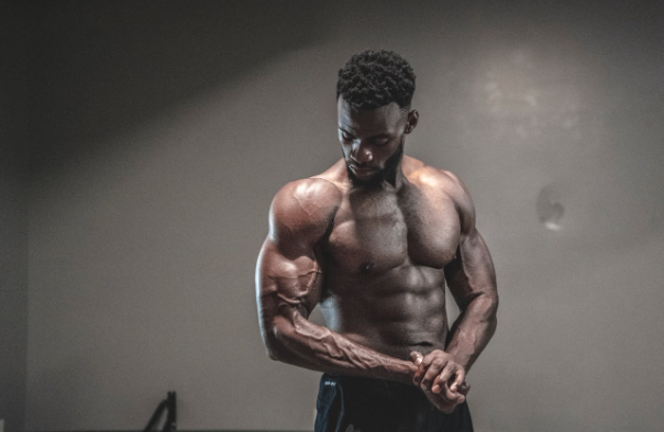 Muscular man demonstrating a push pull legs workout routine